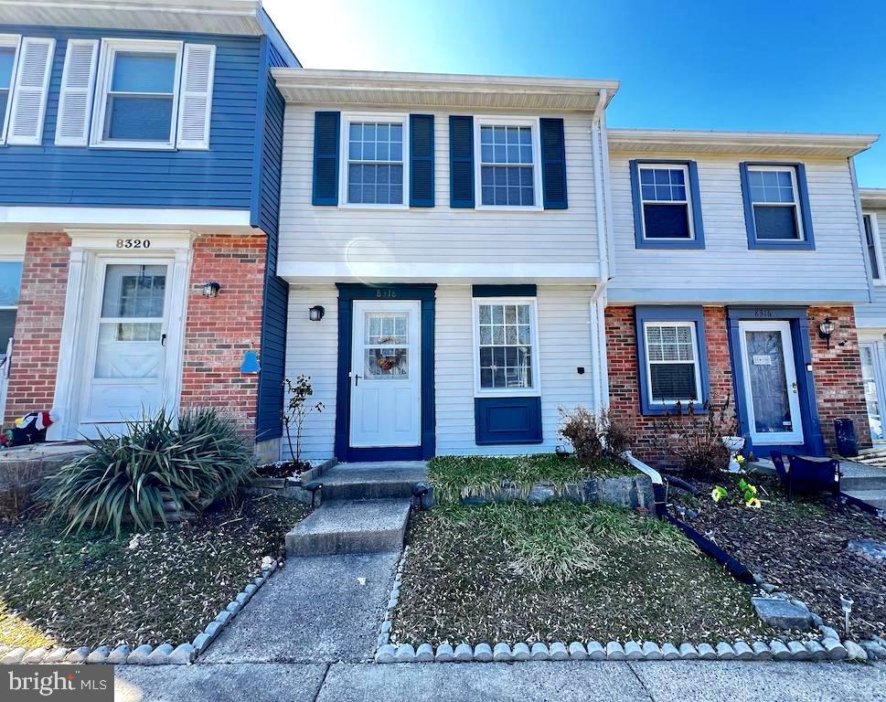 8318 Brookvale Court Springfield, VA 22153 - Photo 1 of 21 a view of a brick house with lots of plants and large trees