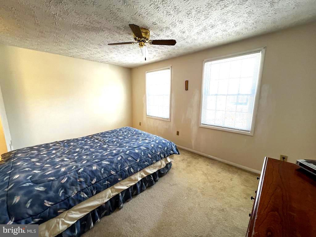 8318 Brookvale Court Springfield, VA 22153 - Photo 12 of 21 a bedroom with bed and window