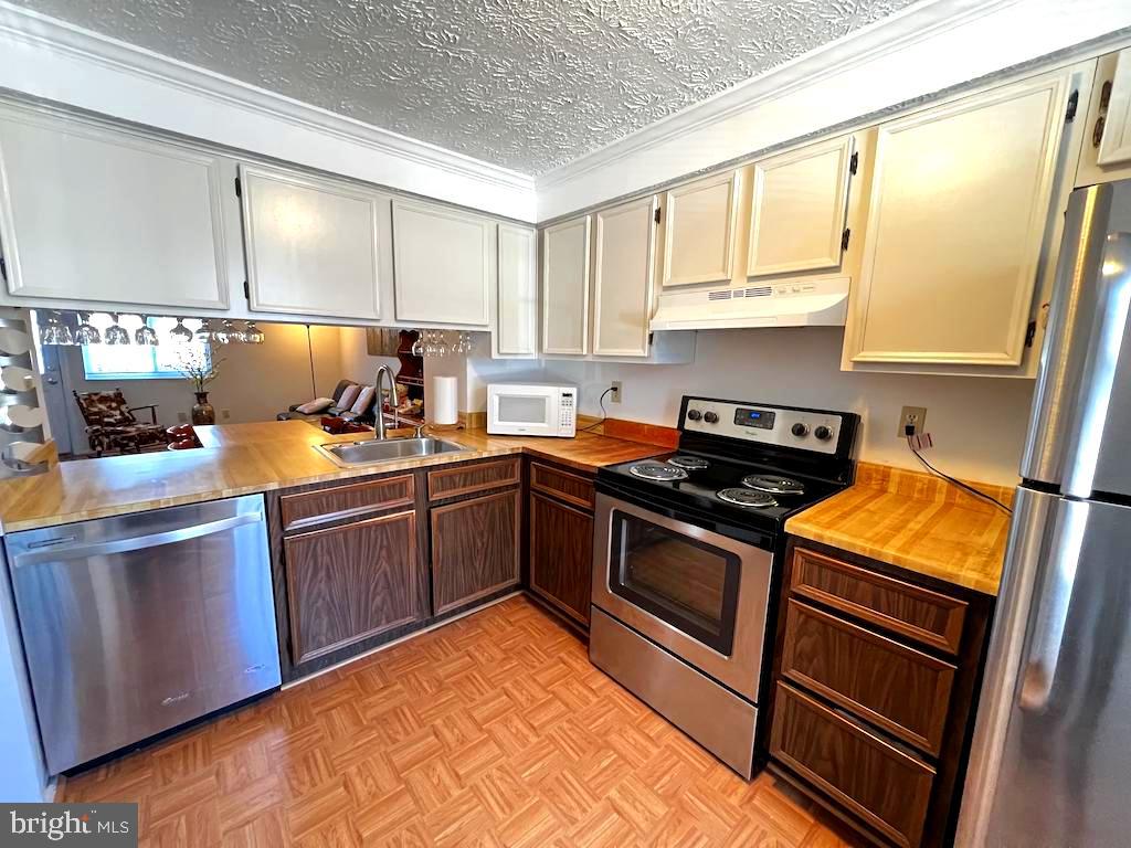8318 Brookvale Court Springfield, VA 22153 - Photo 5 of 21 a kitchen with a sink stove and cabinets