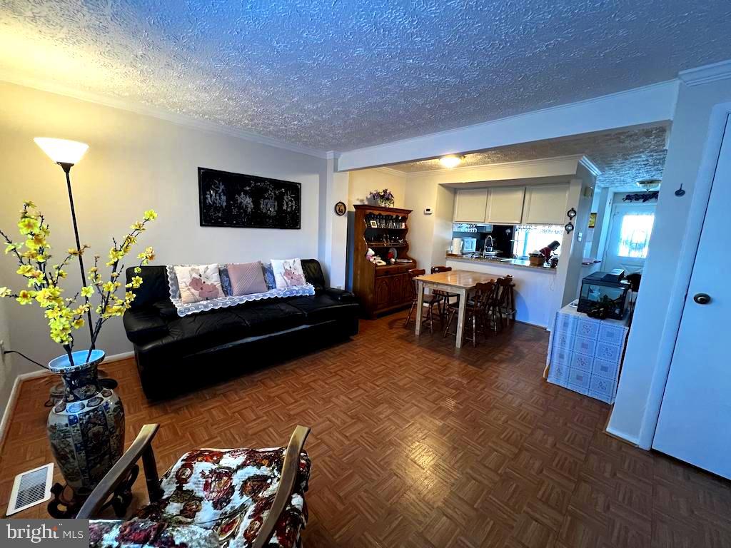 8318 Brookvale Court Springfield, VA 22153 - Photo 7 of 21 a living room with furniture and a flat screen tv
