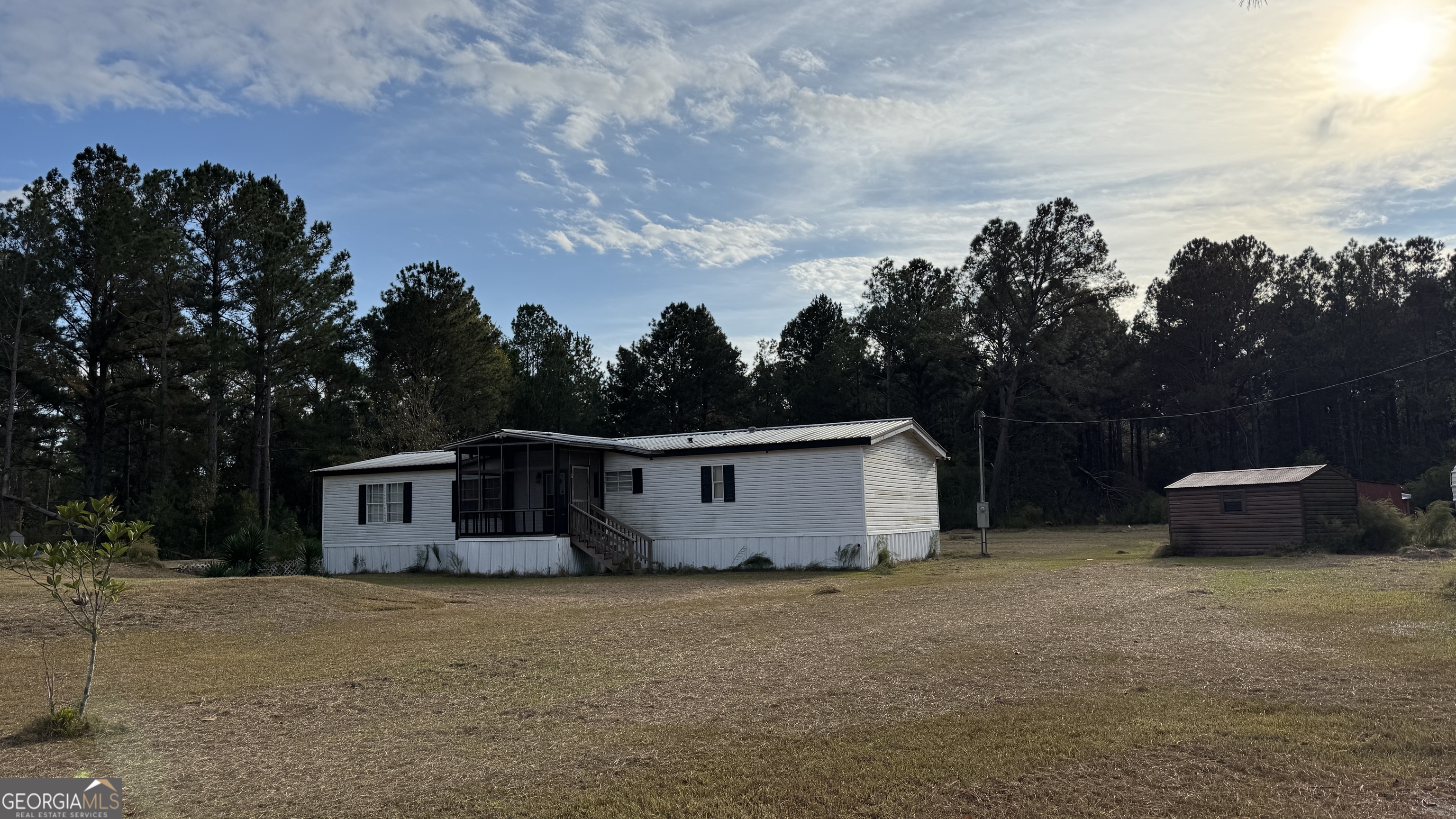 a view of a house with backyard and a tree