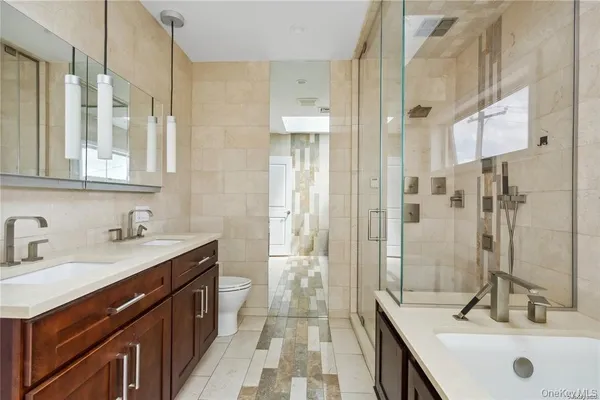 a bathroom with a sink a toilet and shower