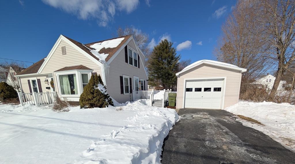 a view of a white house with a yard