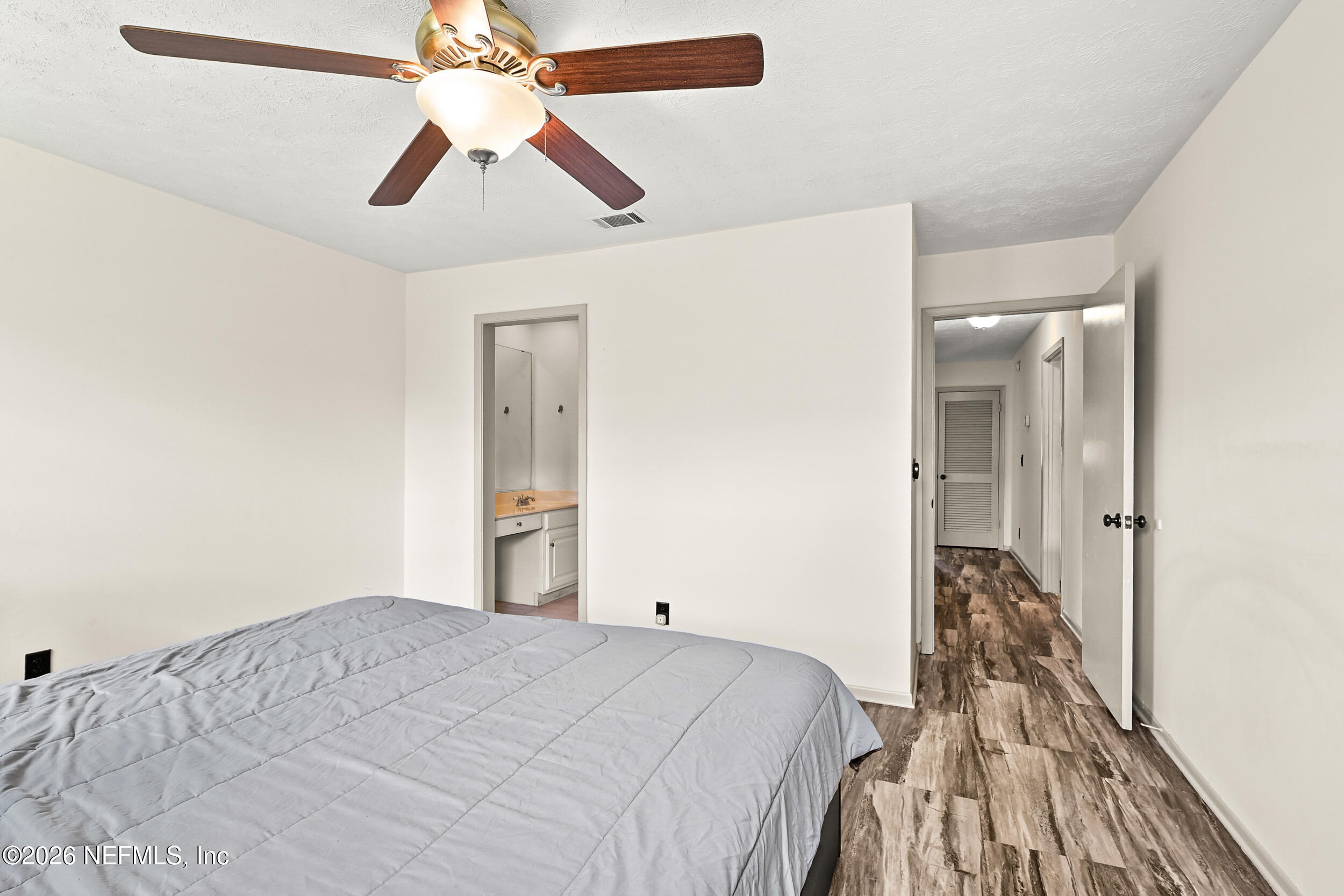 4915 Baymeadows Road, Unit 6G Jacksonville, FL 32217 - Photo 18 of 44 a bedroom with a bed and a chandelier