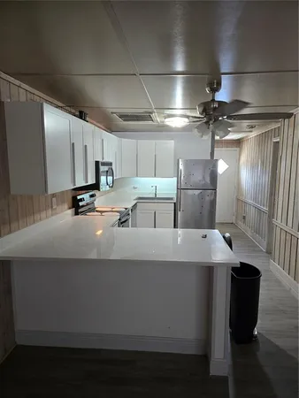 a kitchen with counter top space and stainless steel appliances