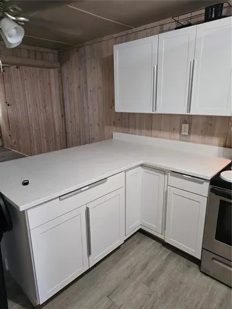 a kitchen with white cabinets and white appliances