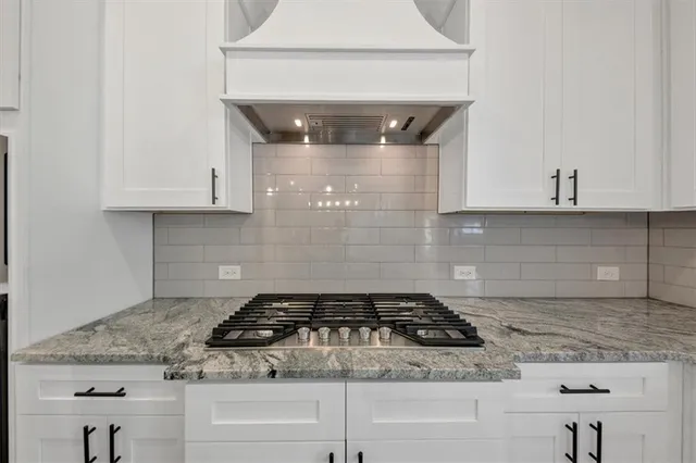 a kitchen with granite countertop a sink and a window