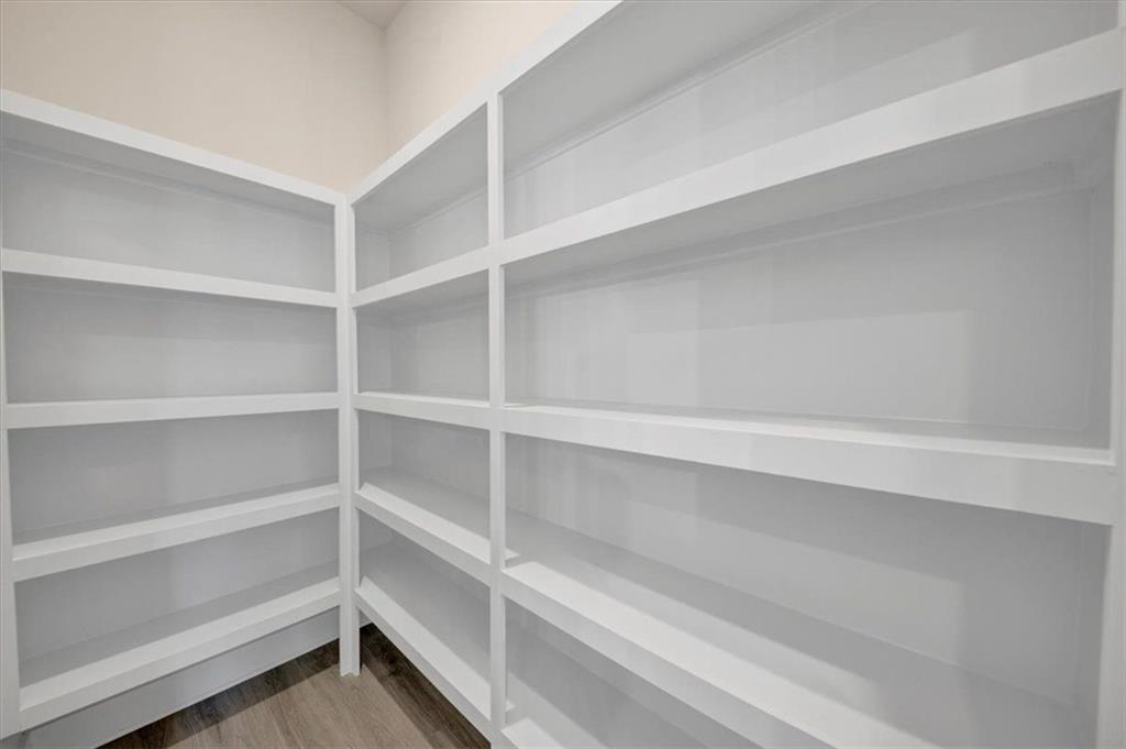 960 Oxford Road Ball Ground, GA 30107 - Photo 20 of 54 a view of walk in closet with empty racks