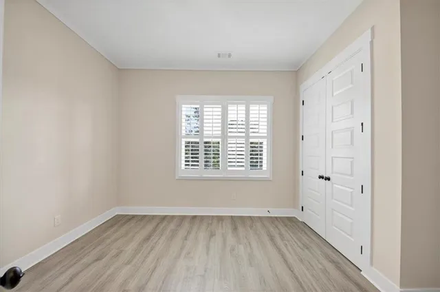 a view of wooden floor and windows in a room