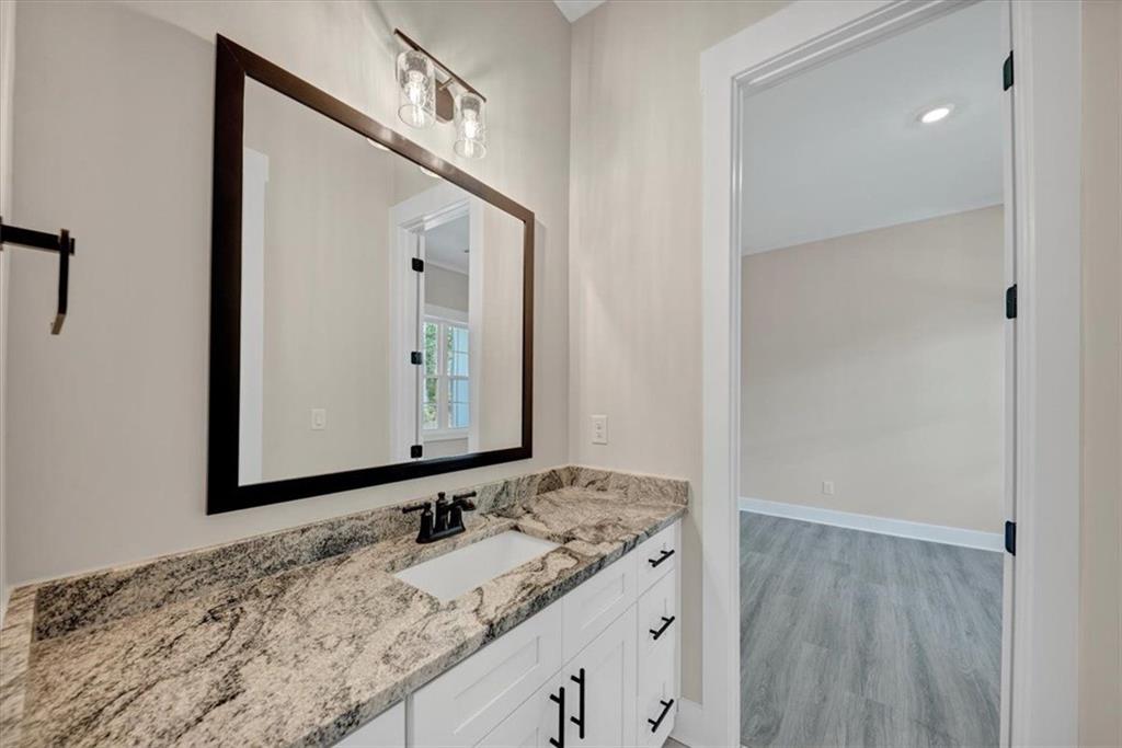 960 Oxford Road Ball Ground, GA 30107 - Photo 23 of 54 a bathroom with a granite countertop sink and a mirror