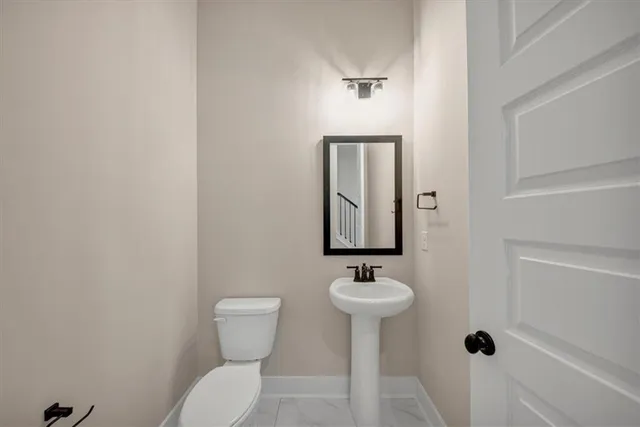 a view of empty room with wooden floor and window
