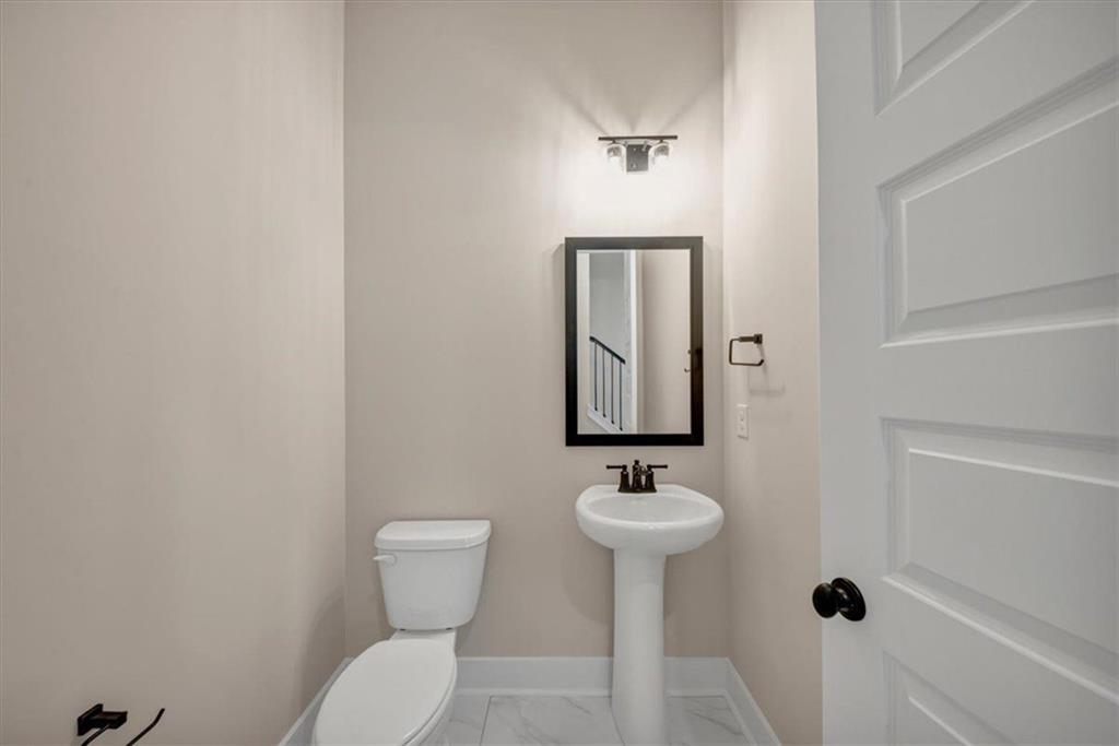 960 Oxford Road Ball Ground, GA 30107 - Photo 27 of 54 a bathroom with a toilet sink shower and mirror