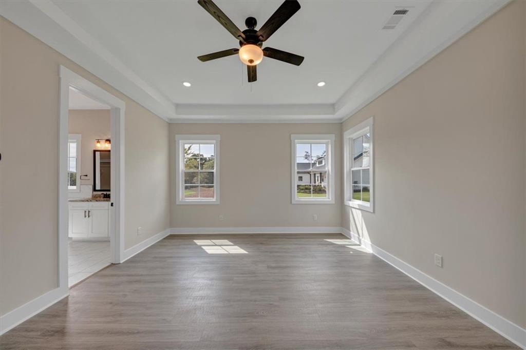 960 Oxford Road Ball Ground, GA 30107 - Photo 28 of 54 a view of an empty room with window and wooden floor