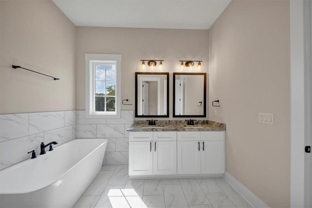960 Oxford Road Ball Ground, GA 30107 - Photo 33 of 54 a bathroom with a granite countertop sink and a mirror