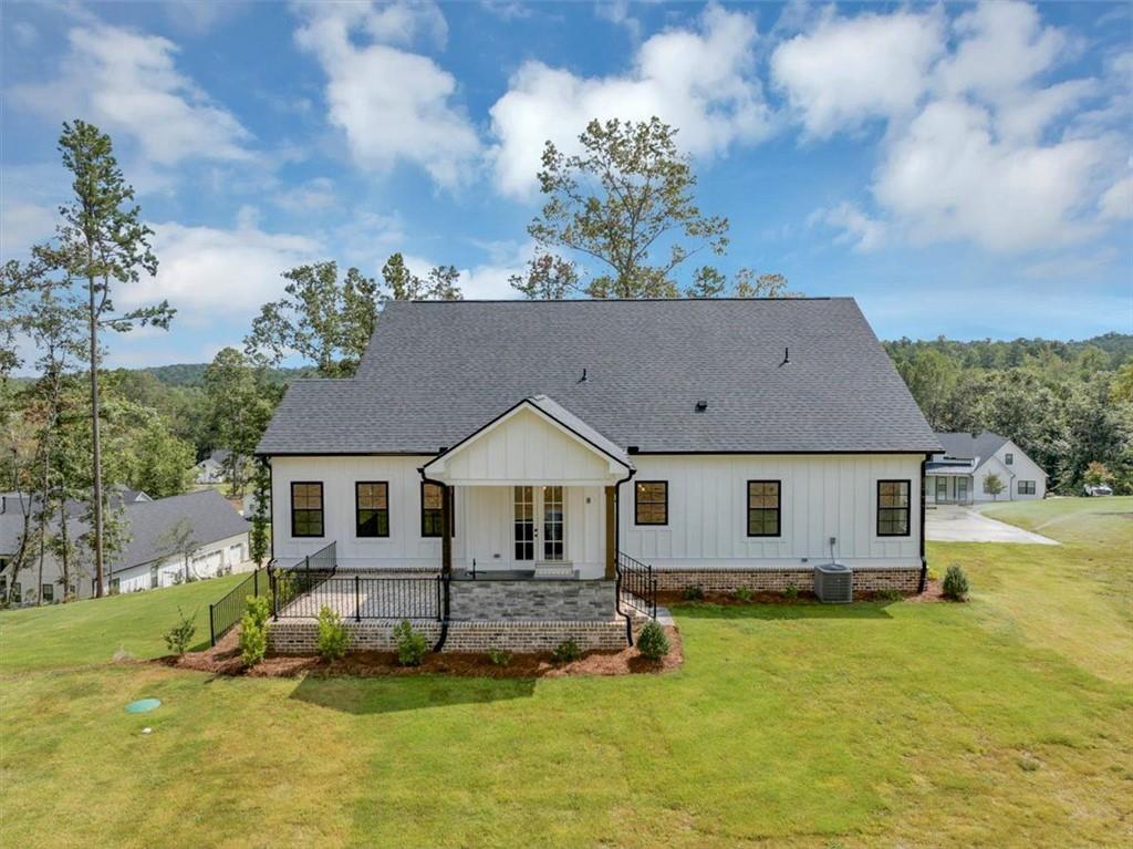 960 Oxford Road Ball Ground, GA 30107 - Photo 47 of 54 a aerial view of a house with a yard table and chairs
