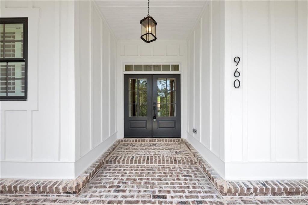 960 Oxford Road Ball Ground, GA 30107 - Photo 6 of 54 a view of a hallway with entryway wooden floor and windows