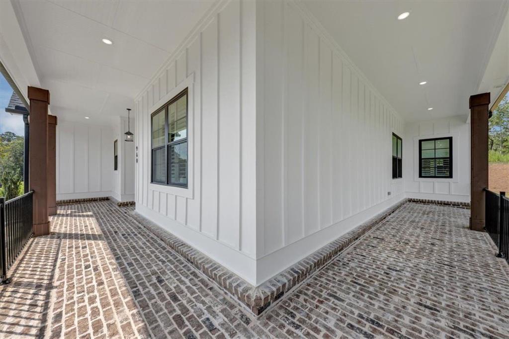 960 Oxford Road Ball Ground, GA 30107 - Photo 7 of 54 a view of a hallway with wooden floor and staircase