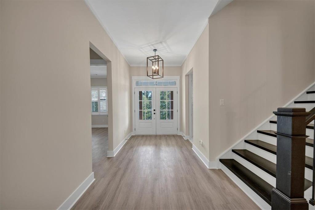 960 Oxford Road Ball Ground, GA 30107 - Photo 8 of 54 a view of a hallway with wooden floor and workspace