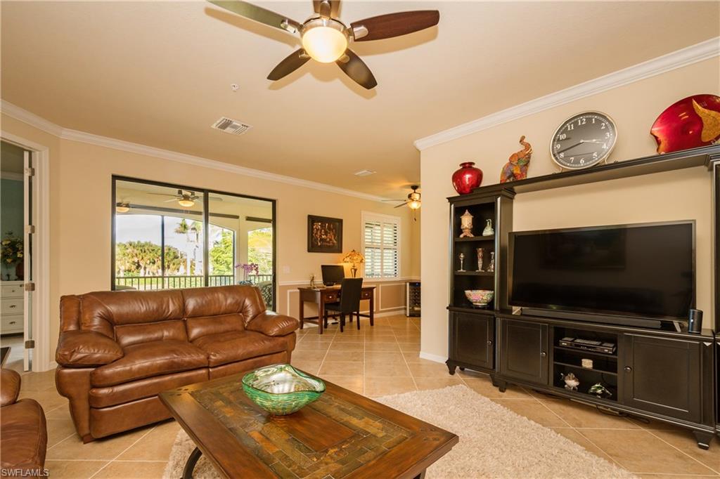9511 Napoli Lane, Unit 202 Naples, FL 34113 - Photo 1 of 24 a living room with furniture and a flat screen tv