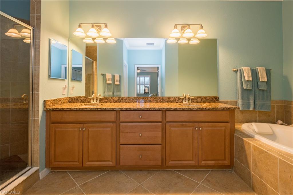 9511 Napoli Lane, Unit 202 Naples, FL 34113 - Photo 12 of 24 a bathroom with a sink and a mirror
