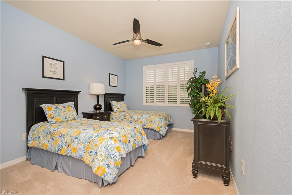 9511 Napoli Lane, Unit 202 Naples, FL 34113 - Photo 13 of 24 a bedroom with bed and window