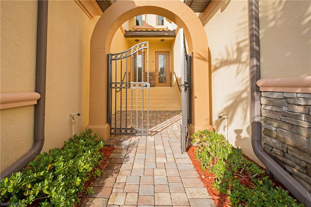 9511 Napoli Lane, Unit 202 Naples, FL 34113 - Photo 22 of 24 a view of a brick house with a fountain
