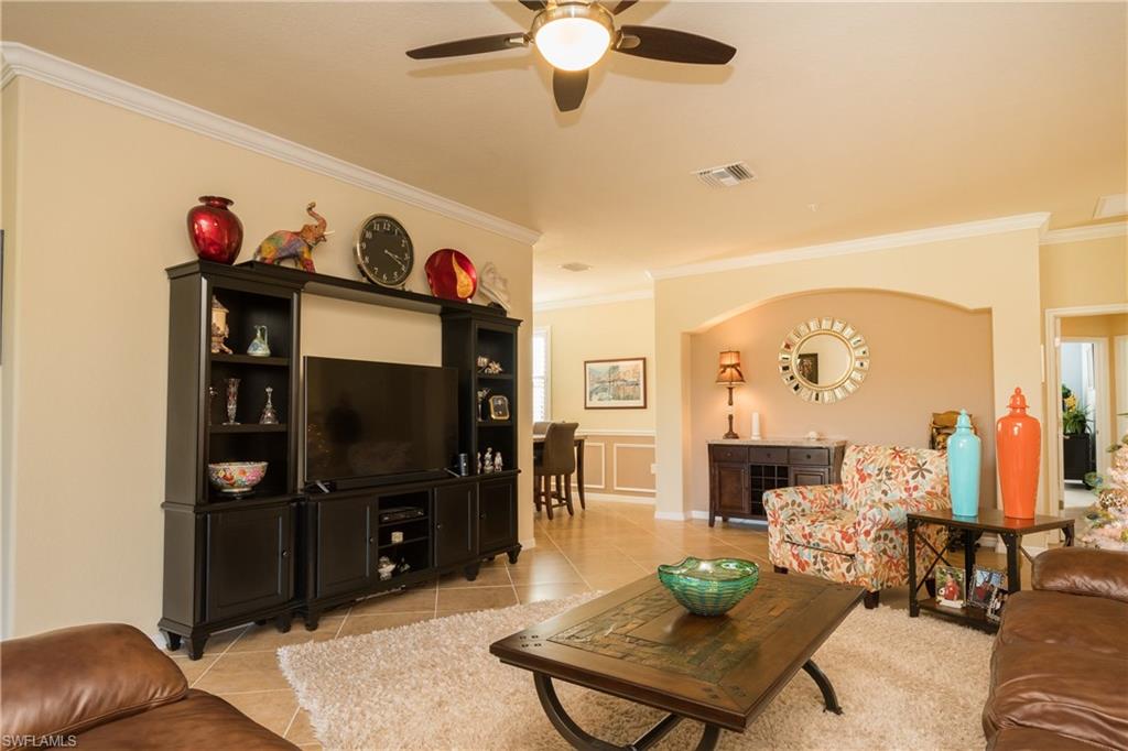9511 Napoli Lane, Unit 202 Naples, FL 34113 - Photo 4 of 24 a living room with furniture and a flat screen tv