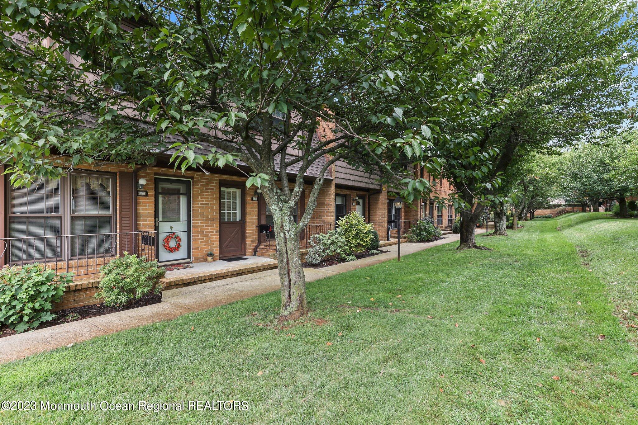 301 Spring Street, Unit 1 Red Bank, NJ 07701 - Photo 3 of 23 front view of a house with a yard