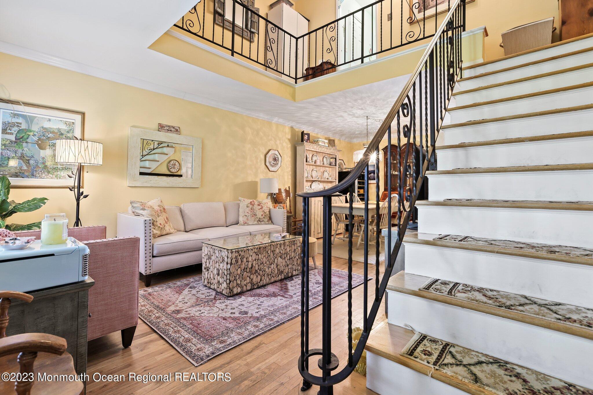 301 Spring Street, Unit 1 Red Bank, NJ 07701 - Photo 5 of 23 a living room with furniture or stairs and a rug