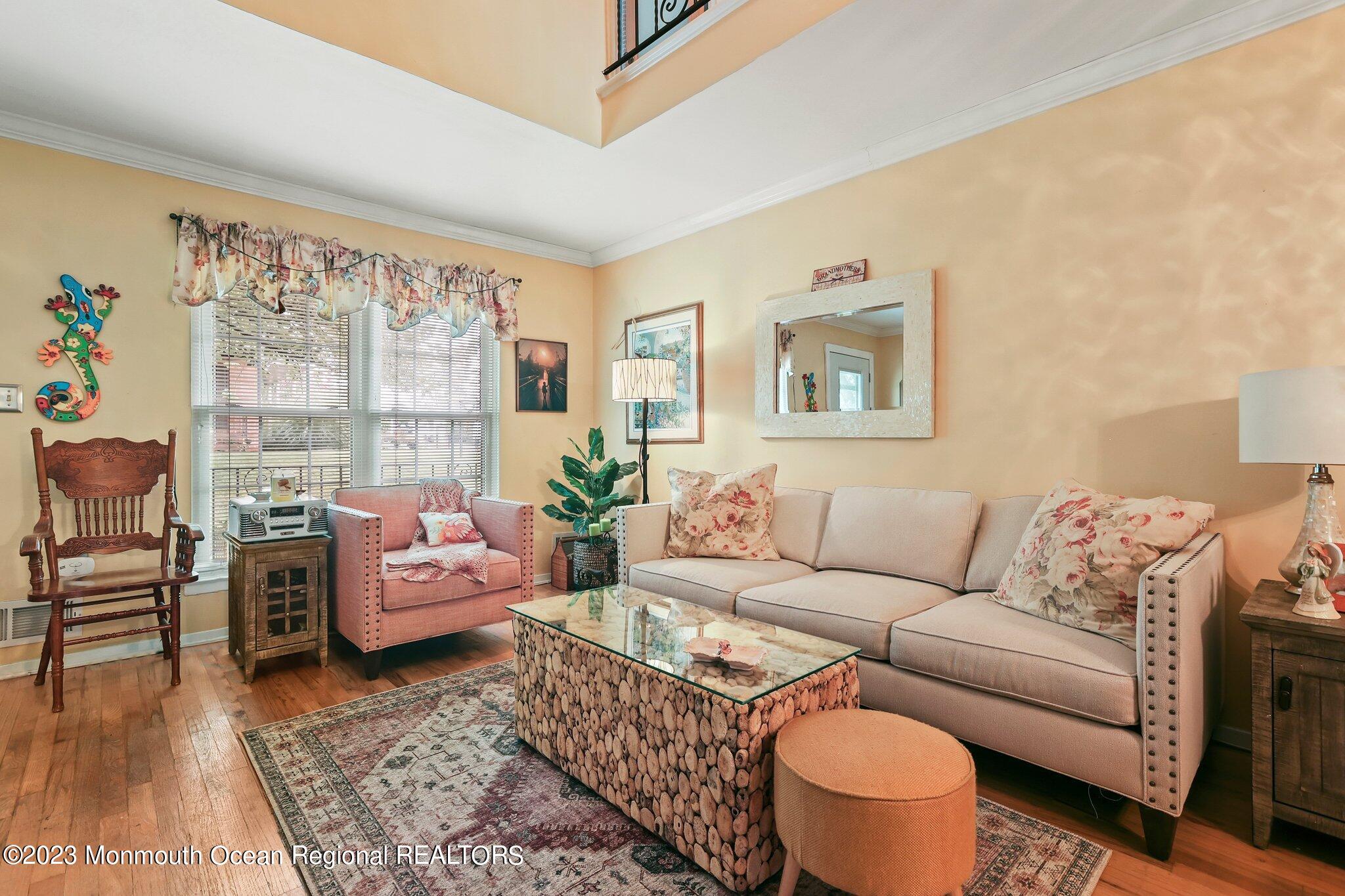 301 Spring Street, Unit 1 Red Bank, NJ 07701 - Photo 7 of 23 a living room with furniture and a large window with garden view