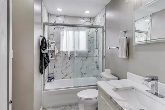 a bathroom with a sink toilet tub and shower