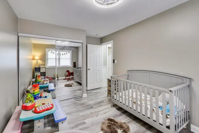 a bedroom with baby crib and furniture
