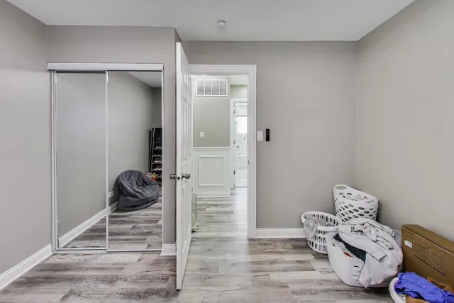 a room with a baby crib and a dresser