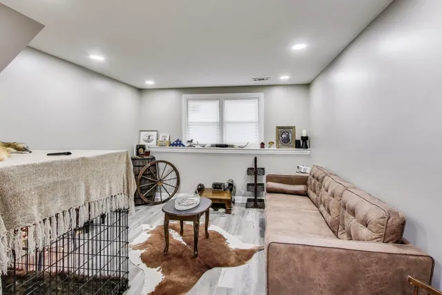 a living room with furniture a rug and a window