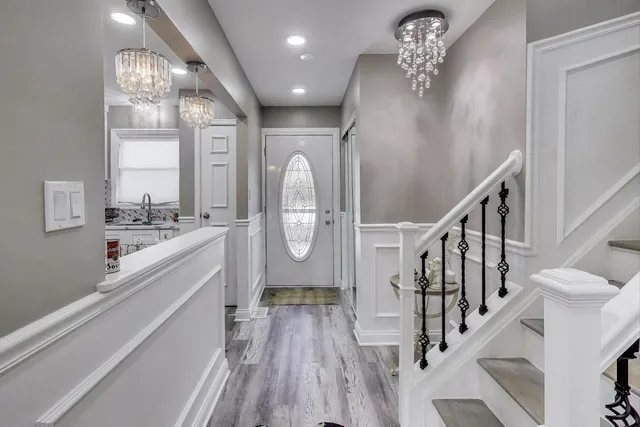 a view of entryway and hall with wooden floor