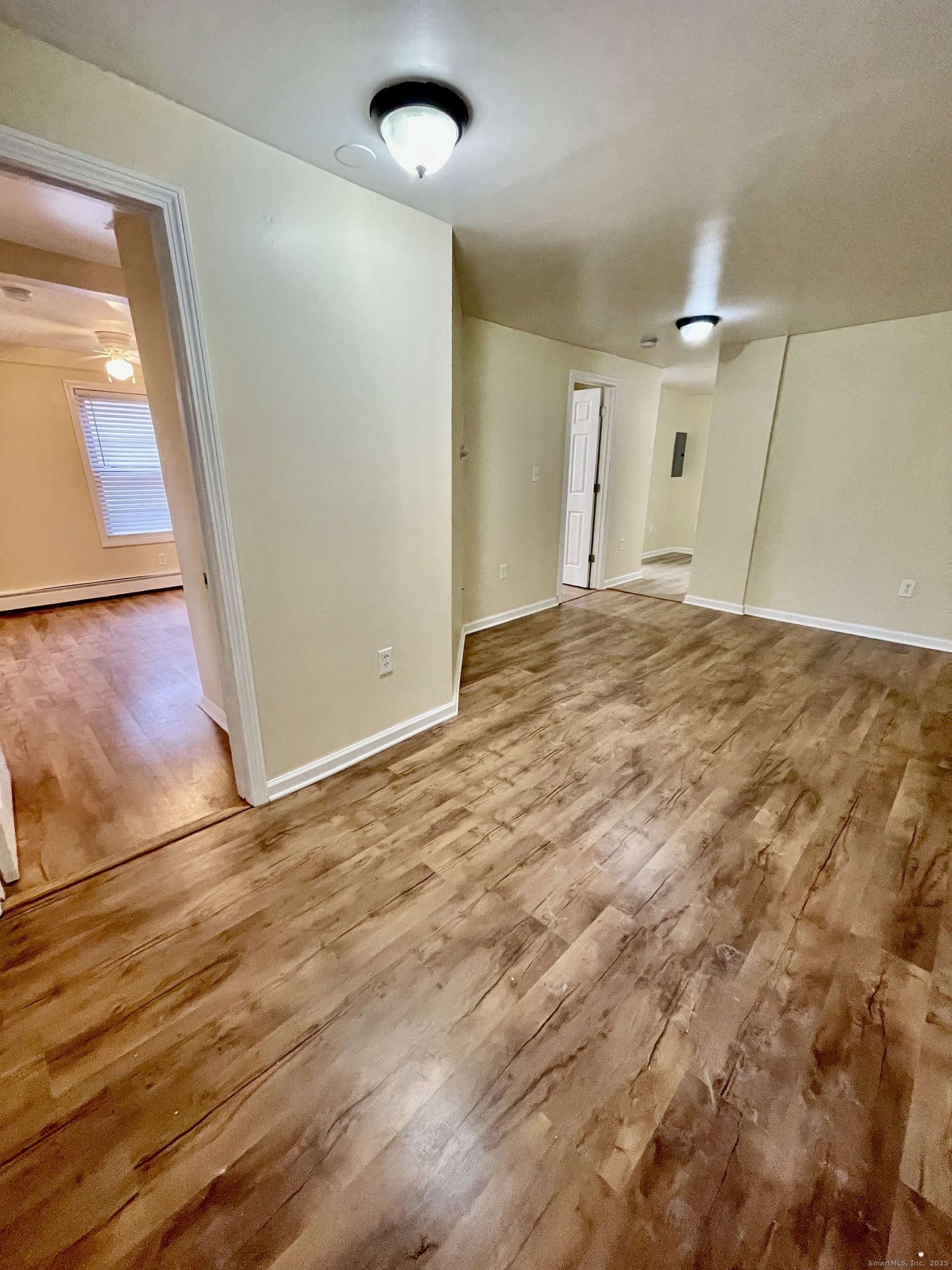 92 West Main Street, Unit 3 Vernon, CT 06066 - Photo 11 of 13 an empty room with wooden floor and door