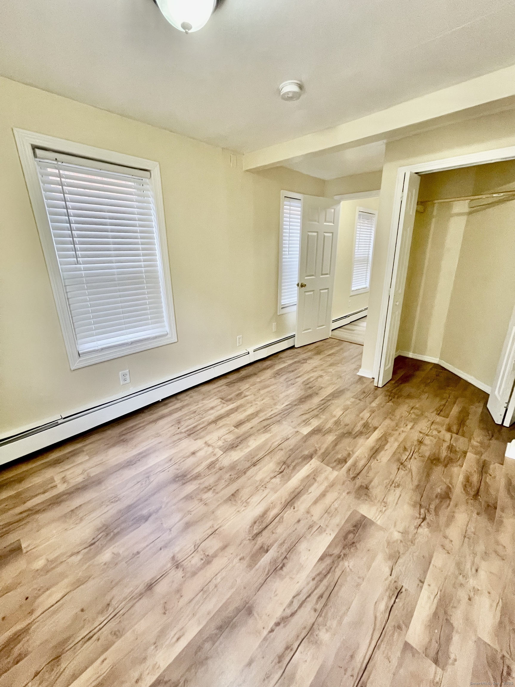 92 West Main Street, Unit 3 Vernon, CT 06066 - Photo 6 of 13 a view of an empty room with wooden floor and a window