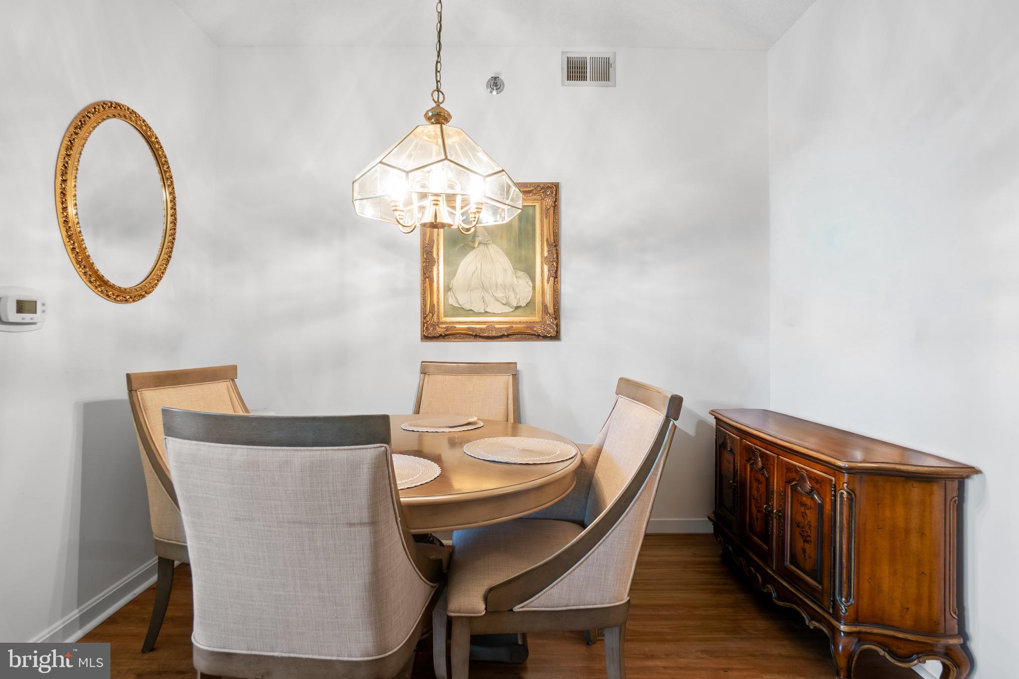 3005 South Leisure World Boulevard, Unit 702 Silver Spring, MD 20906 - Photo 13 of 43 a view of a dining room with furniture and a chandelier
