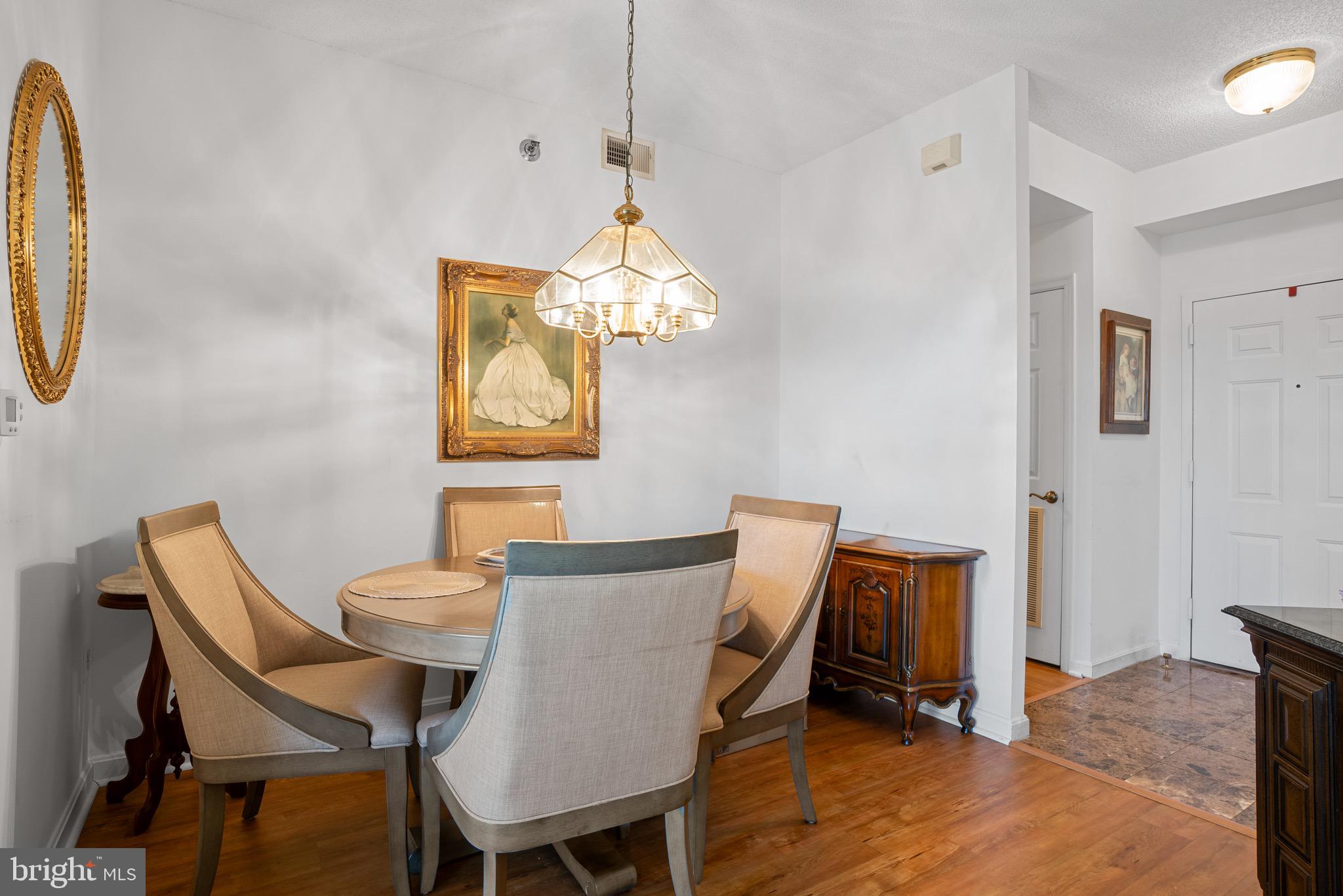3005 South Leisure World Boulevard, Unit 702 Silver Spring, MD 20906 - Photo 14 of 43 a dining room with furniture and a mirror