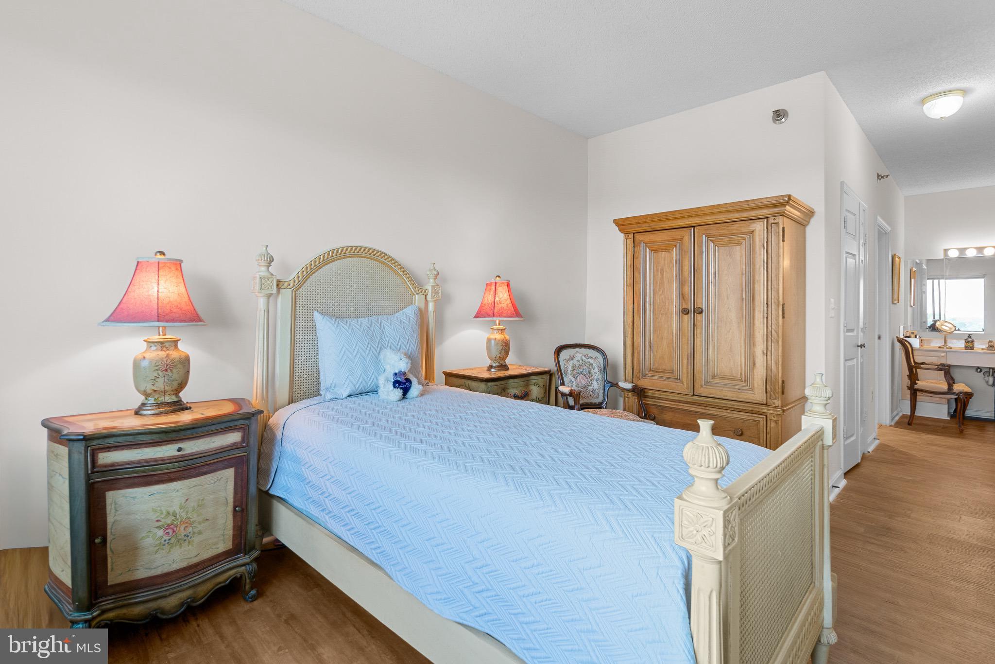 3005 South Leisure World Boulevard, Unit 702 Silver Spring, MD 20906 - Photo 16 of 43 a bedroom with bed and a dresser