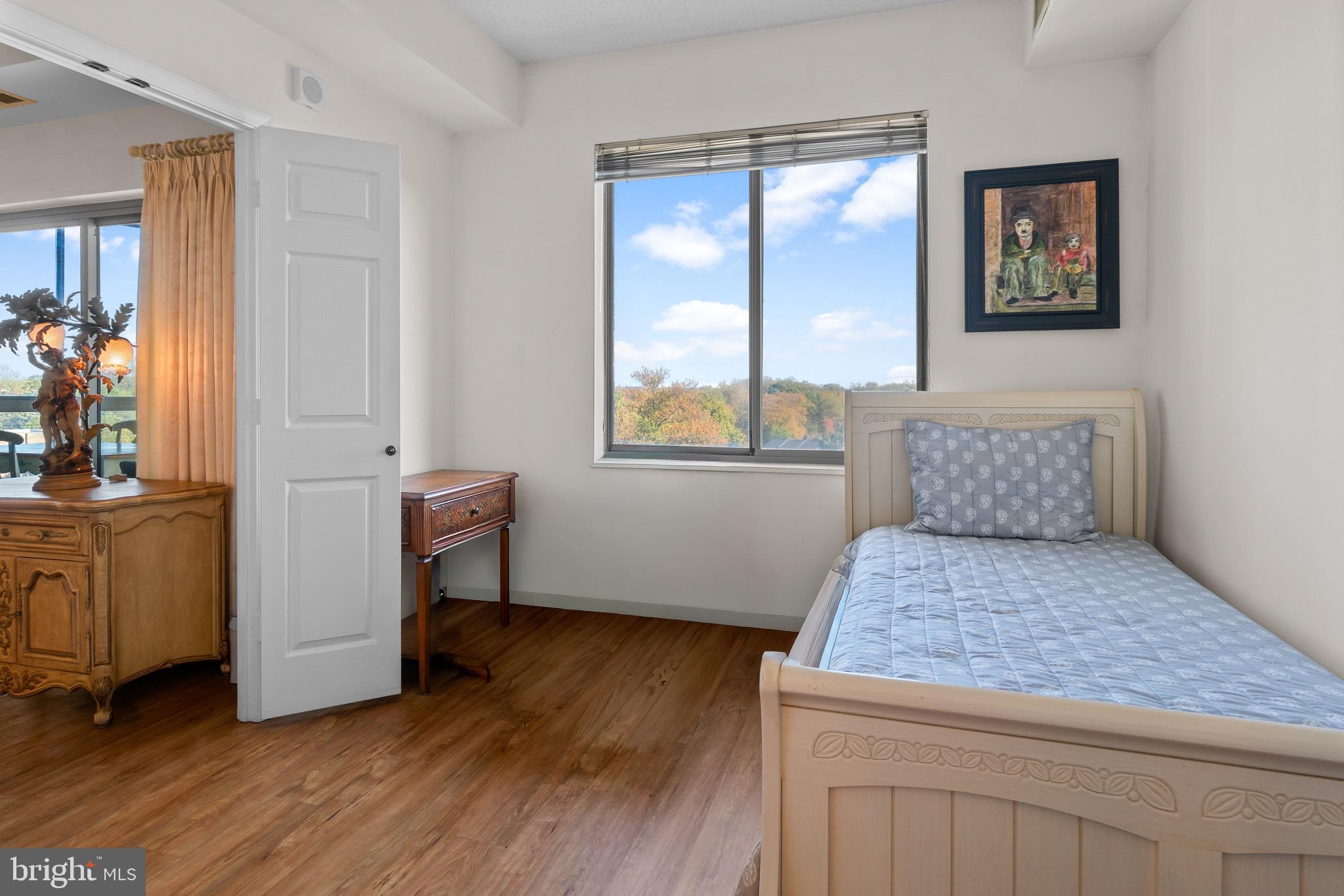 3005 South Leisure World Boulevard, Unit 702 Silver Spring, MD 20906 - Photo 21 of 43 a bedroom with a bed and a window