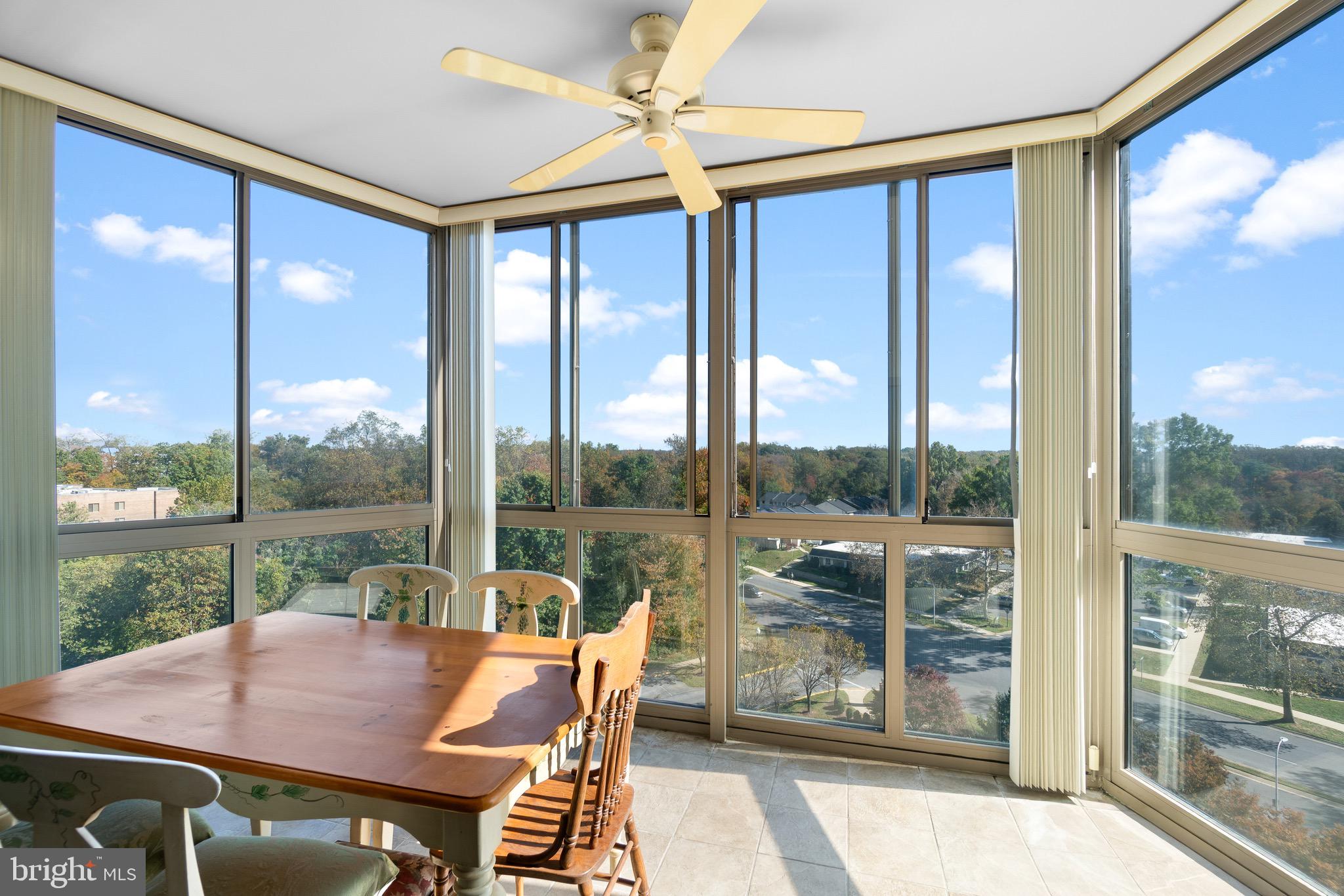 3005 South Leisure World Boulevard, Unit 702 Silver Spring, MD 20906 - Photo 23 of 43 a view of a patio with a table chairs and a porch