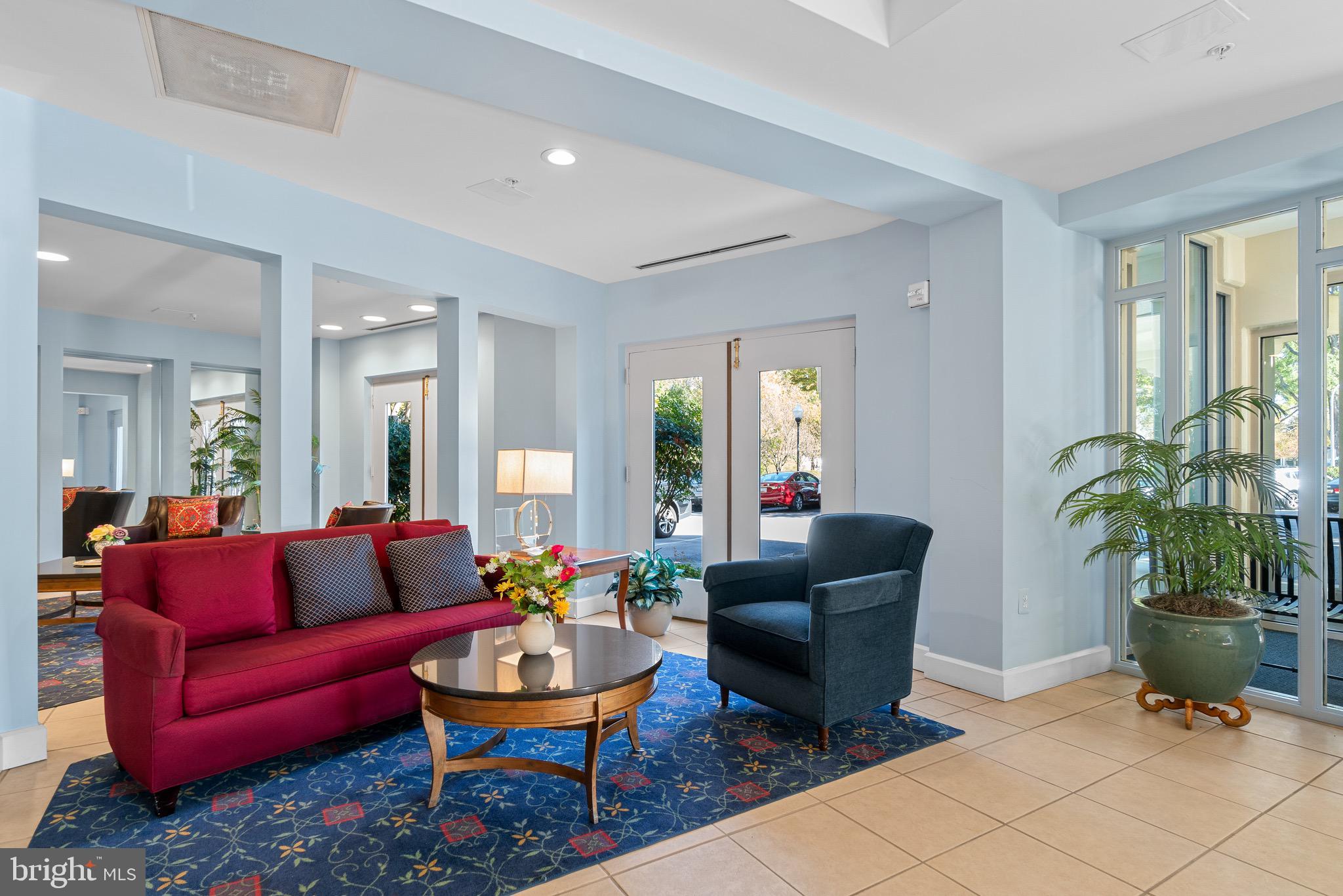 3005 South Leisure World Boulevard, Unit 702 Silver Spring, MD 20906 - Photo 35 of 43 a living room with furniture potted plant and a window