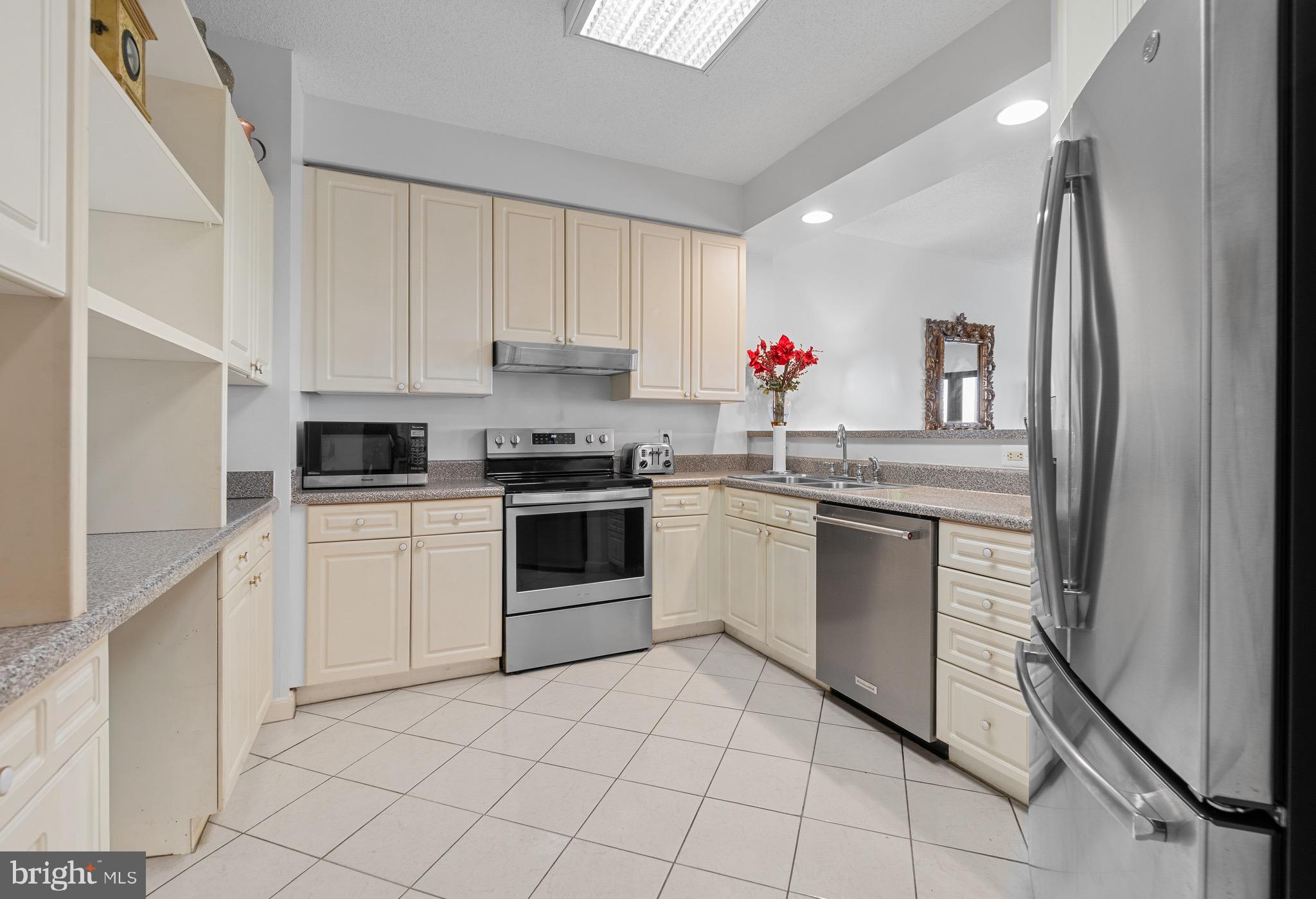 3005 South Leisure World Boulevard, Unit 702 Silver Spring, MD 20906 - Photo 6 of 43 a kitchen with white cabinets and white appliances