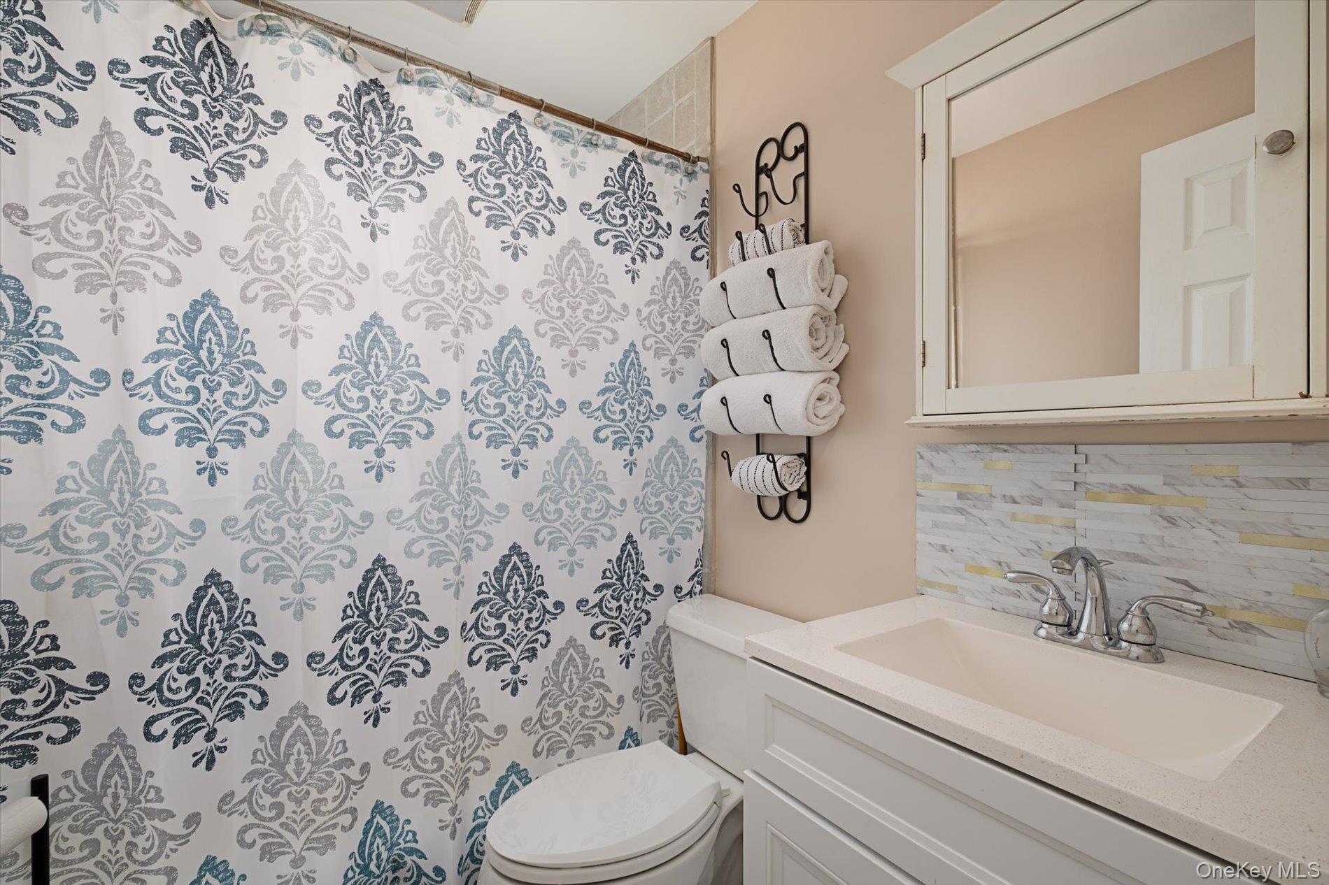 675 Little E Neck Road West Babylon, NY 11704 - Photo 9 of 20 a bathroom with a sink toilet and shower