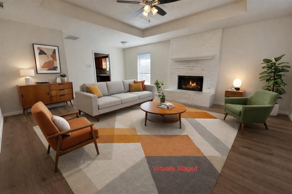 a living room with furniture and a fireplace