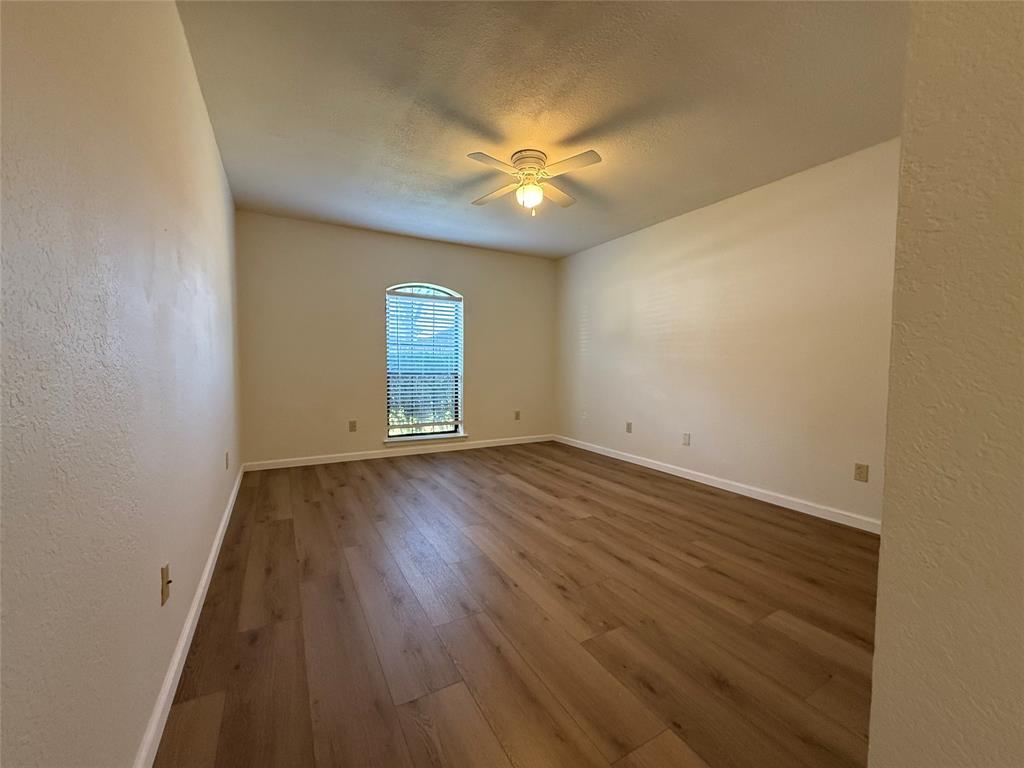 526 Post Oak Lane Allen, TX 75002 - Photo 13 of 18 an empty room with wooden floor and windows