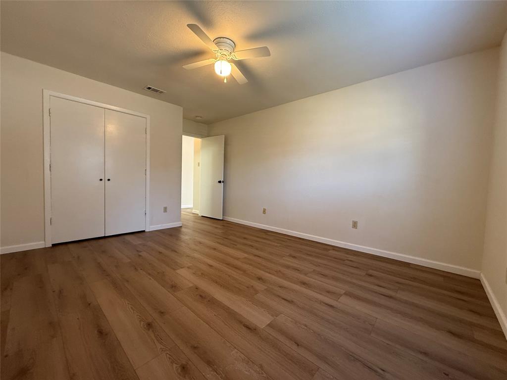 526 Post Oak Lane Allen, TX 75002 - Photo 14 of 18 an empty room with wooden floor and windows
