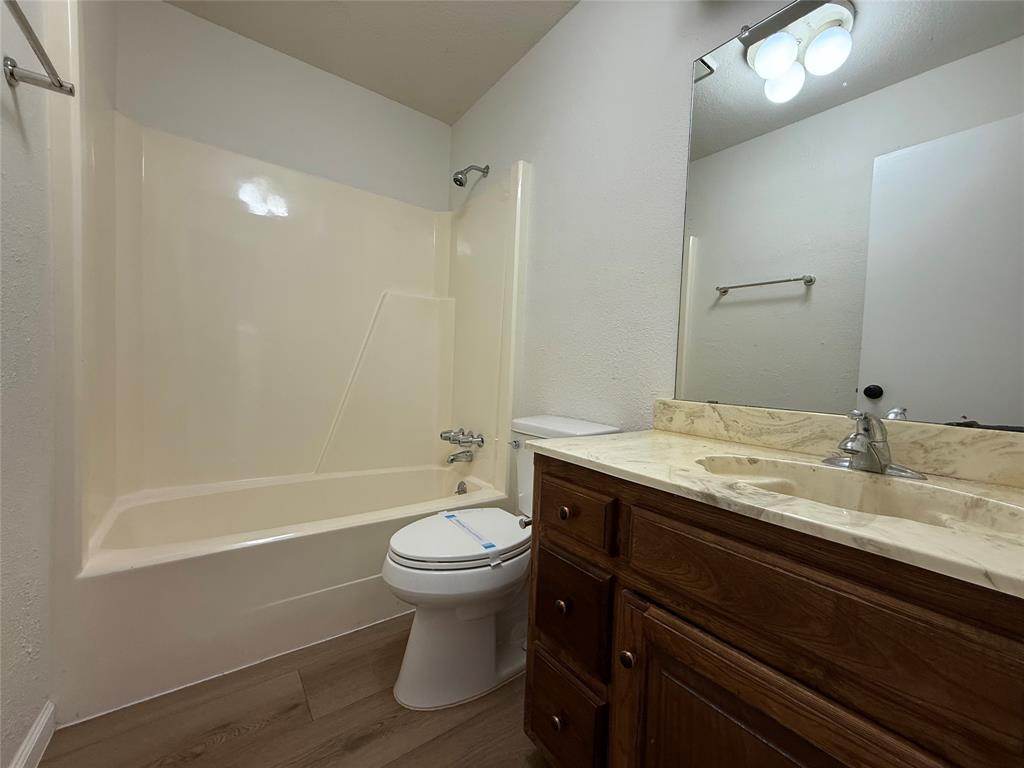526 Post Oak Lane Allen, TX 75002 - Photo 15 of 18 a bathroom with a granite countertop sink toilet and shower