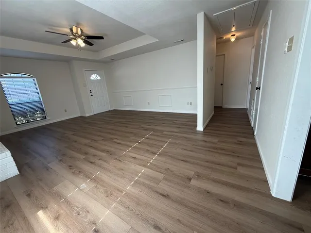 a view of an empty room and wooden floor